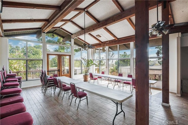 sunroom with french doors, lofted ceiling with beams, baseboards, and wood finished floors
