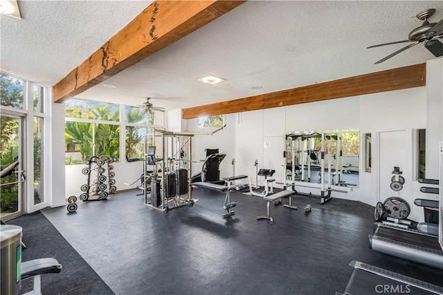 gym with ceiling fan and a textured ceiling