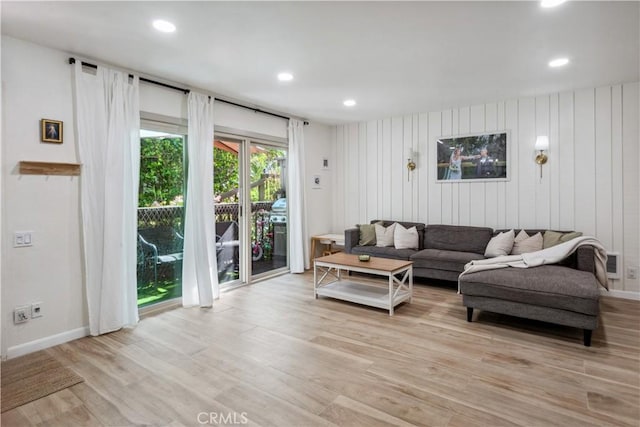 living area with recessed lighting, baseboards, and light wood finished floors