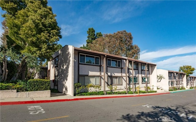 view of property with uncovered parking
