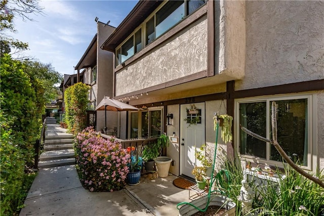 exterior space with a patio area and stucco siding