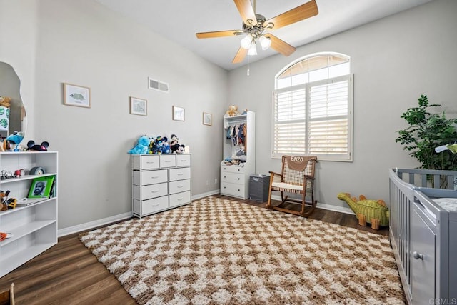 bedroom with visible vents, baseboards, and wood finished floors
