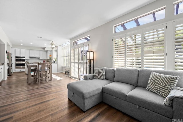 living room with ceiling fan, recessed lighting, visible vents, and dark wood-type flooring