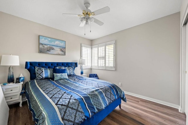 bedroom featuring a ceiling fan, baseboards, and wood finished floors