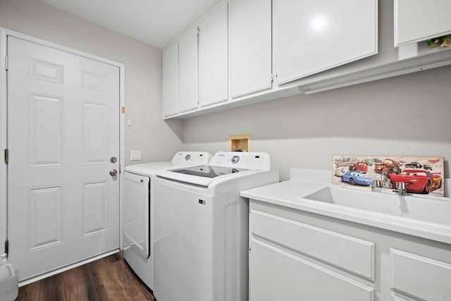 laundry area with cabinet space, a sink, dark wood-style floors, and washer and clothes dryer