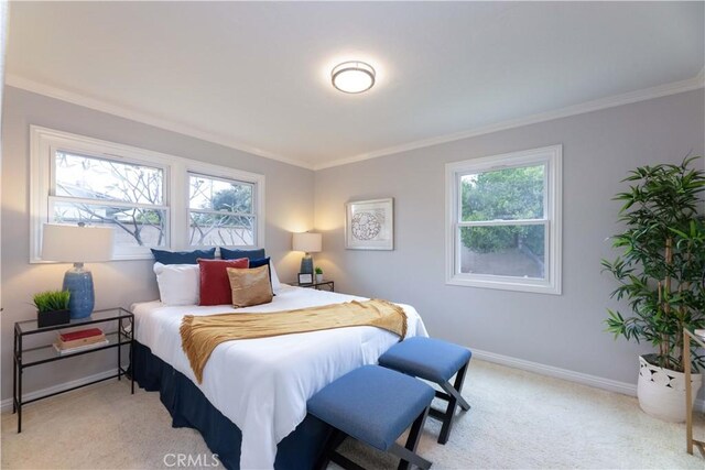 bedroom with multiple windows, baseboards, ornamental molding, and light colored carpet