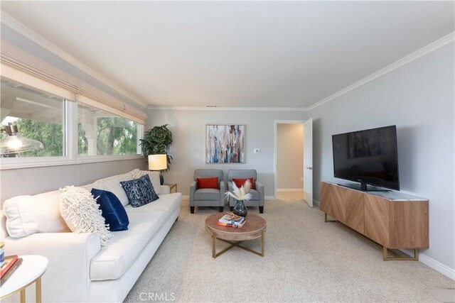 living area with light carpet, ornamental molding, and baseboards