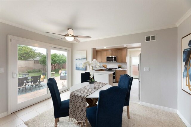 dining space featuring ornamental molding, baseboards, and ceiling fan