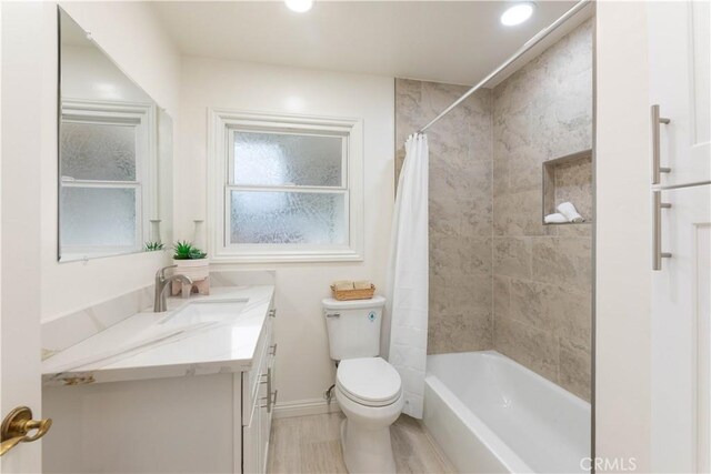 full bath with vanity, toilet, recessed lighting, shower / bath combination with curtain, and baseboards
