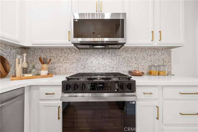 kitchen with gas range oven, stainless steel microwave, white cabinets, and light countertops