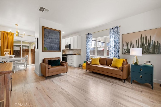 living area featuring visible vents, baseboards, a chandelier, recessed lighting, and light wood-style flooring