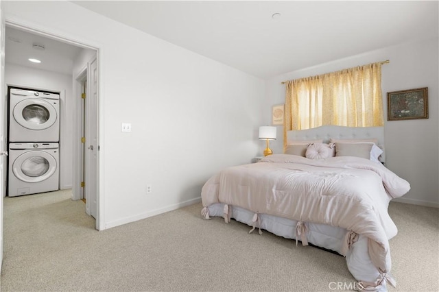 bedroom with carpet flooring, stacked washer / drying machine, and baseboards