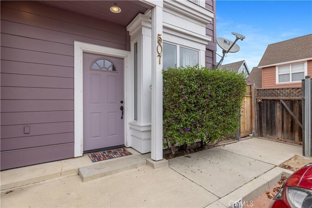 entrance to property featuring fence
