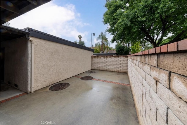 view of patio / terrace featuring fence