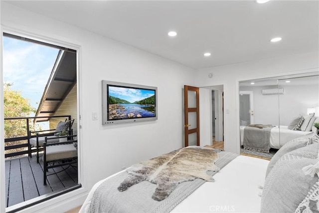 bedroom with a closet, recessed lighting, a wall mounted air conditioner, and wood finished floors