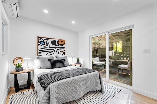 bedroom featuring recessed lighting, baseboards, access to exterior, and wood finished floors