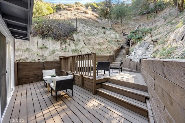 deck featuring stairway and fence