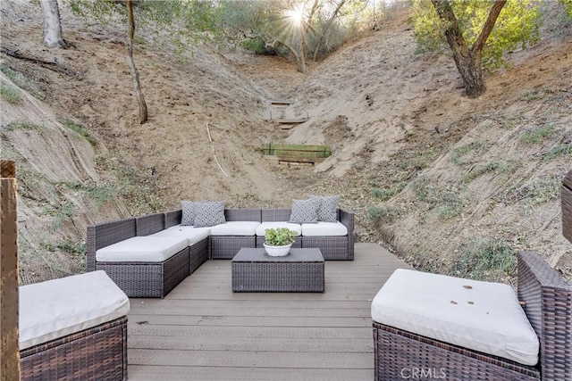 wooden terrace with an outdoor living space