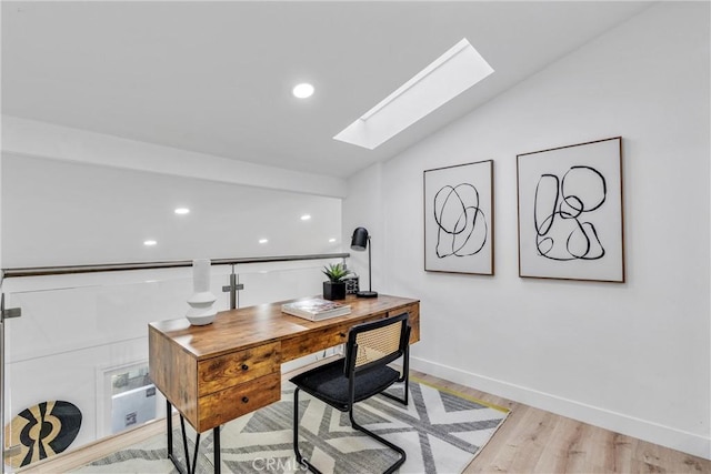 home office featuring recessed lighting, baseboards, light wood-style flooring, and vaulted ceiling with skylight
