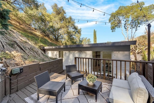 wooden deck with an outdoor living space