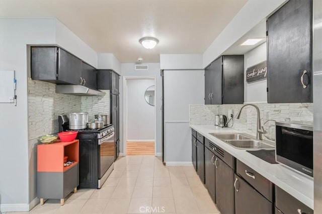 44650 2nd St E, Lancaster, CA 93535 - kitchen with stainless steel stove, a sink, tasteful backsplash, and light countertops