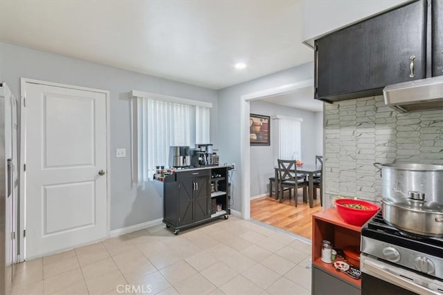 44650 2nd St E, Lancaster, CA 93535 - kitchen featuring range hood, baseboards, recessed lighting, and stainless steel range with gas cooktop