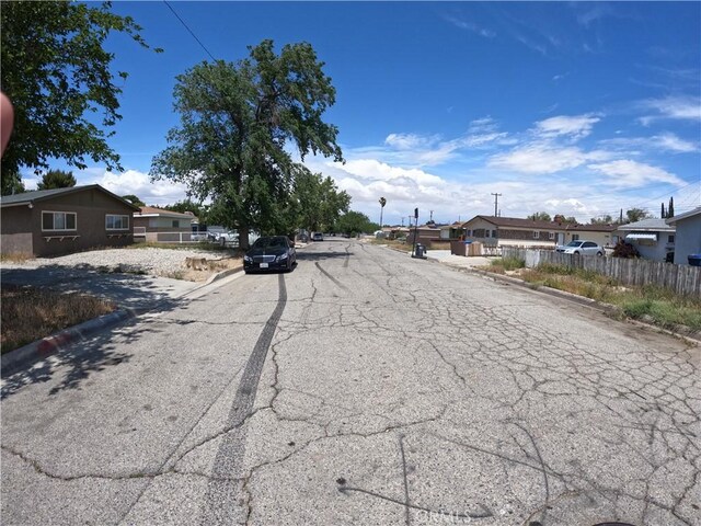 44650 2nd St E, Lancaster, CA 93535 - view of asphalt road with curbs and a residential view