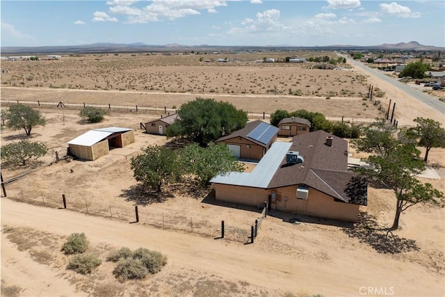 drone / aerial view featuring a desert view, a mountain view, and a rural view