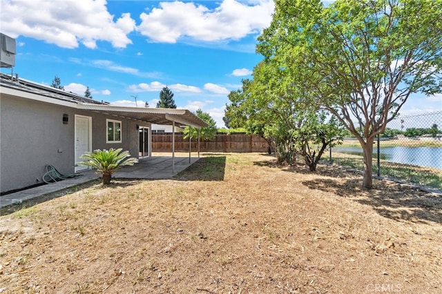 fenced backyard with a patio area