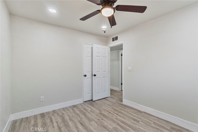 unfurnished bedroom with light wood finished floors, baseboards, and ceiling fan