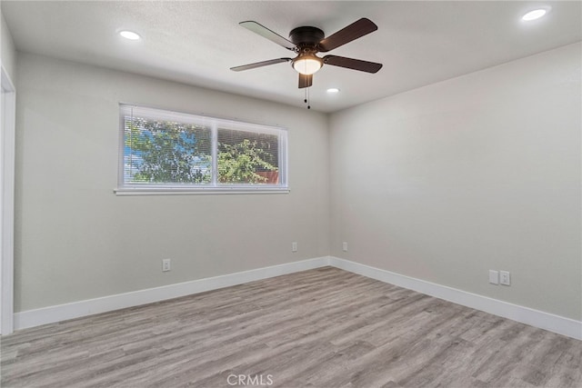 empty room with light wood-style floors, ceiling fan, recessed lighting, and baseboards