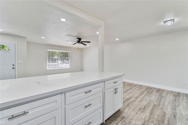 kitchen with recessed lighting, white cabinetry, light wood-style flooring, light stone countertops, and ceiling fan