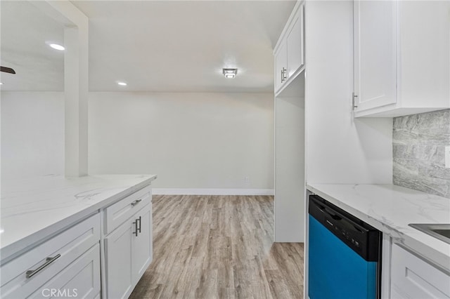 kitchen featuring dishwasher, white cabinets, light wood-style floors, decorative backsplash, and light stone countertops