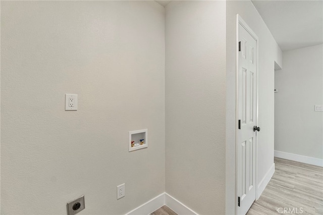 laundry room featuring hookup for a washing machine, baseboards, light wood-style floors, and hookup for an electric dryer
