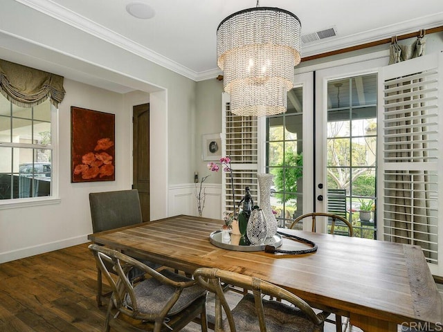 dining area with visible vents, ornamental molding, a notable chandelier, and a wealth of natural light
