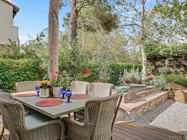 wooden deck featuring outdoor dining area and a patio area