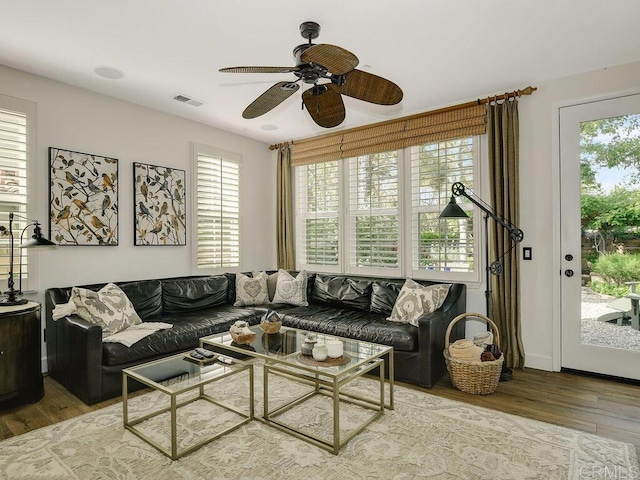 living area featuring visible vents, ceiling fan, and wood finished floors