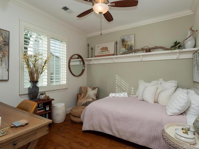 bedroom featuring ceiling fan, ornamental molding, wood finished floors, and visible vents