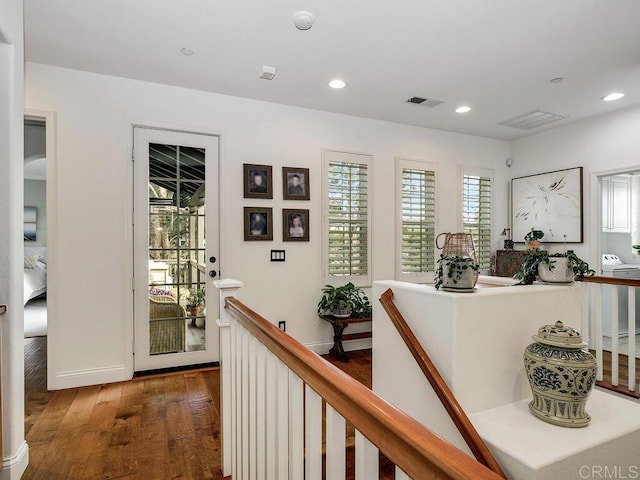 interior space with visible vents, baseboards, an upstairs landing, recessed lighting, and hardwood / wood-style floors