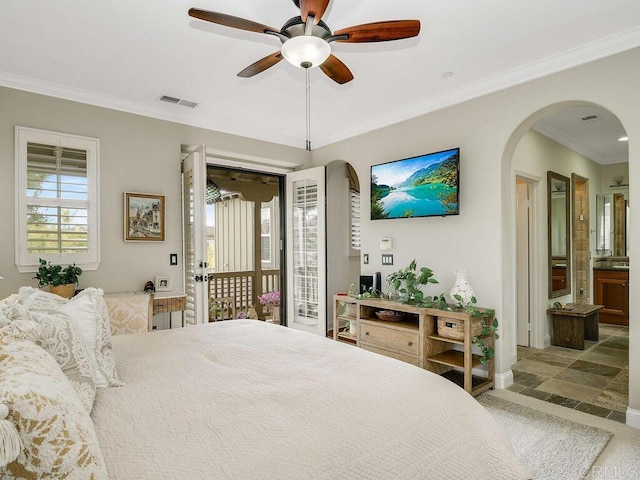 bedroom featuring arched walkways, multiple windows, access to outside, and visible vents