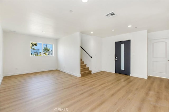 entrance foyer with stairs, recessed lighting, baseboards, and light wood-type flooring