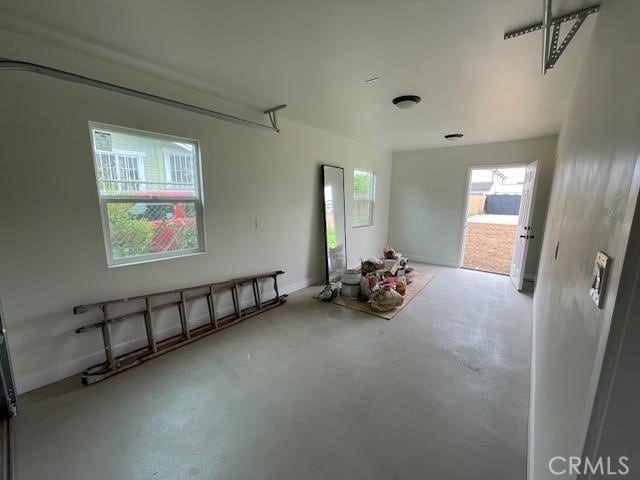 interior space featuring concrete flooring and baseboards