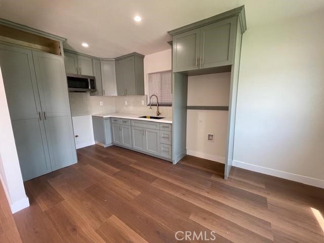 1539 E 87th St, Los Angeles, CA 90002 - kitchen with stainless steel microwave, a sink, tasteful backsplash, baseboards, and recessed lighting