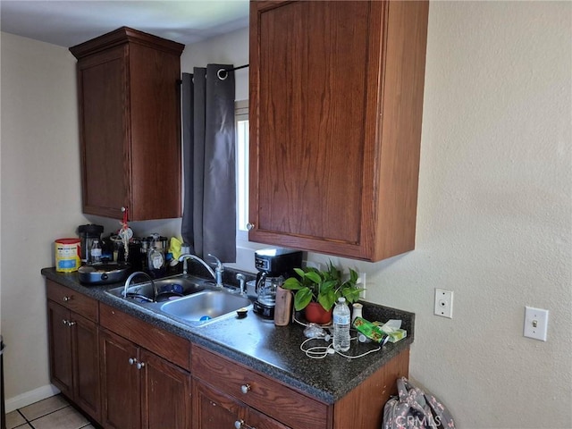 409 E Belmont St, Ontario, CA 91761 - kitchen with a sink, dark countertops, and light tile patterned floors