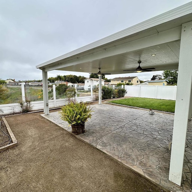 view of patio featuring ceiling fan and fence