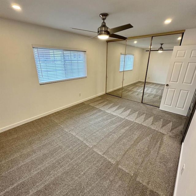 unfurnished bedroom featuring carpet flooring, recessed lighting, baseboards, a ceiling fan, and a closet