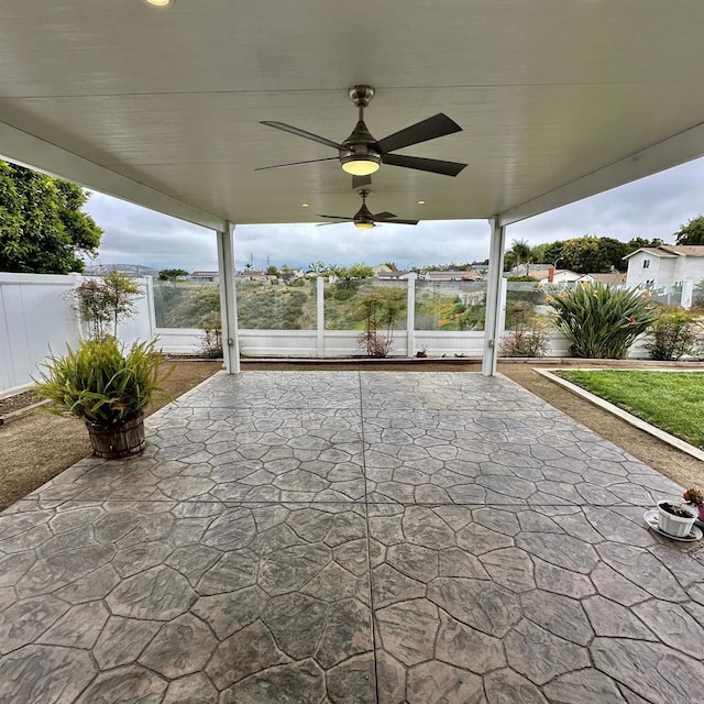 view of patio featuring fence and a ceiling fan
