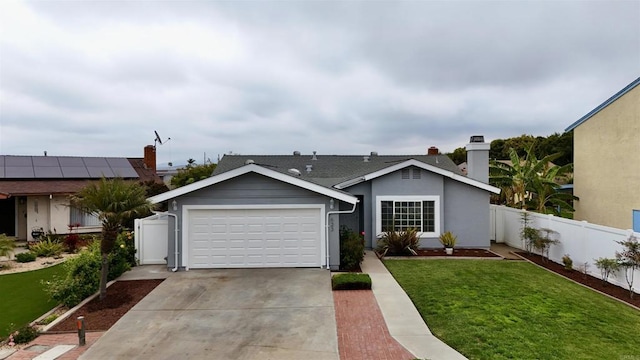 single story home with fence, an attached garage, driveway, and a front yard