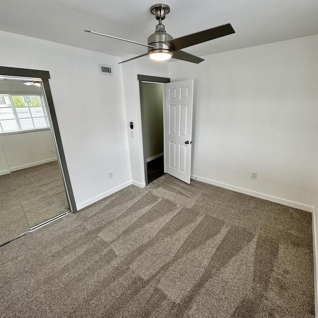 unfurnished bedroom featuring visible vents, carpet, and baseboards