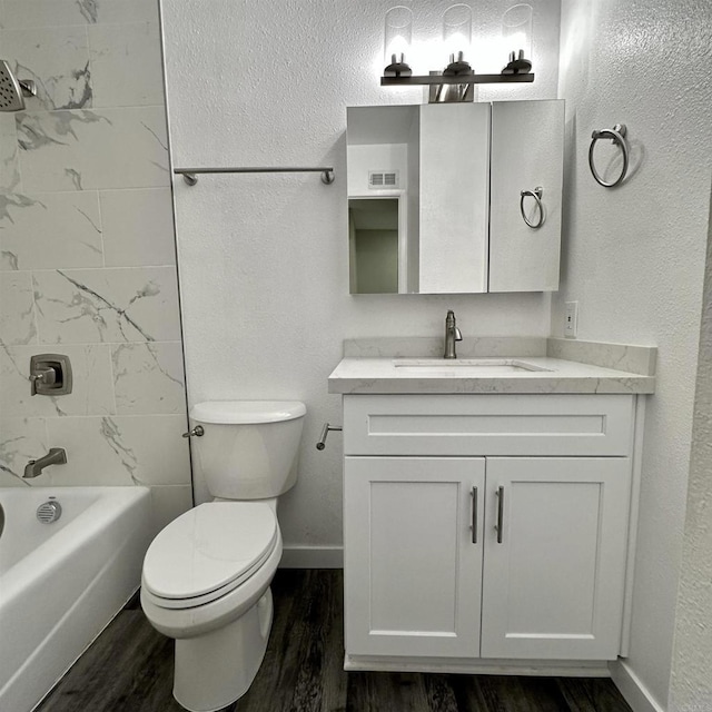 bathroom with visible vents, wood finished floors, vanity, baseboards, and toilet